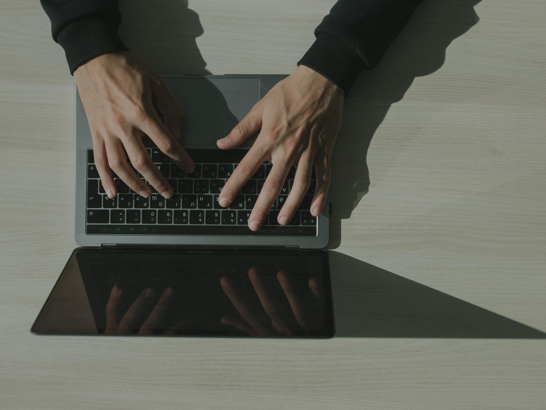 Hands on laptop from above